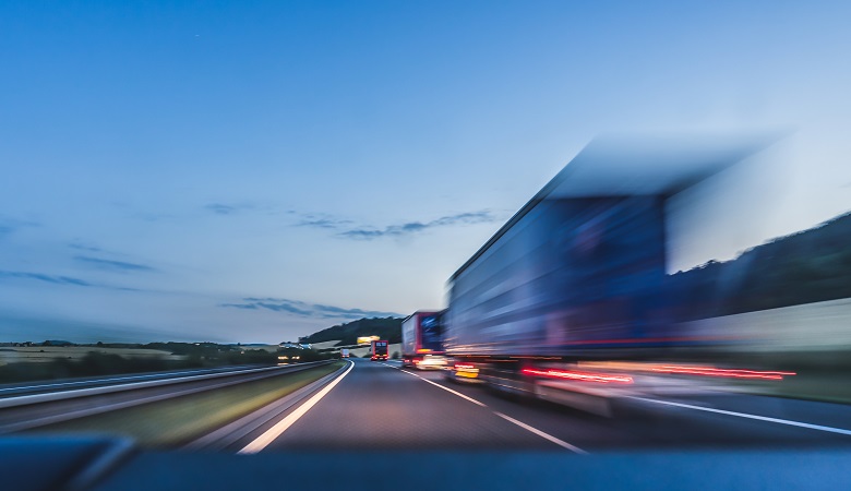 A truck driving down the highway at high speed